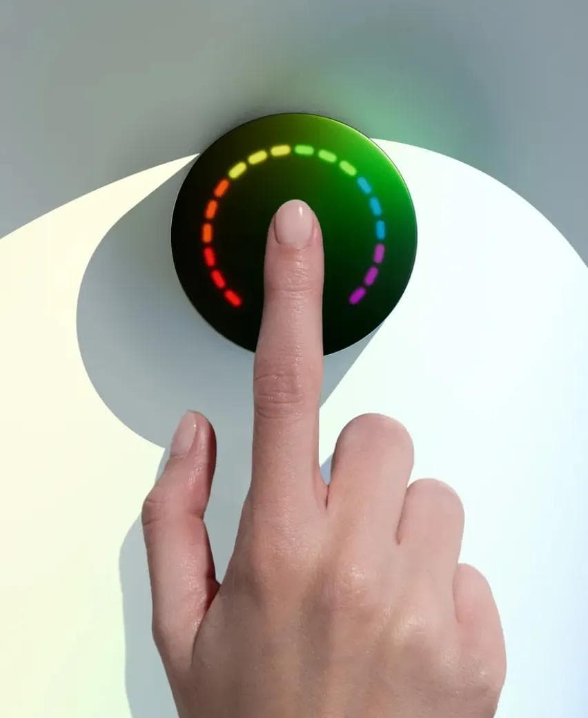 A client's fingertip resting on the Prysm iO scanner during a 15-second wellness reading